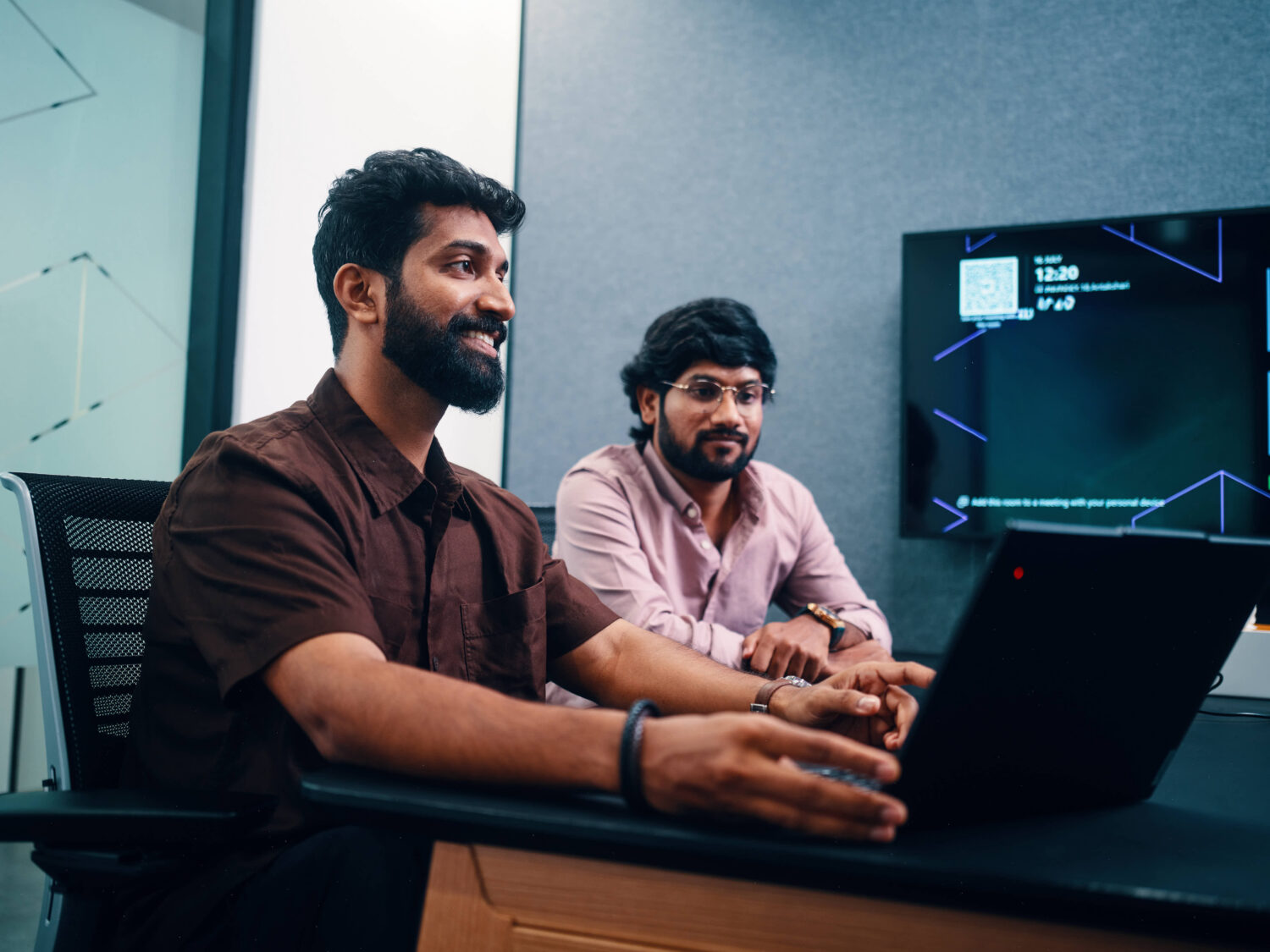 Two people sat at a computer together
