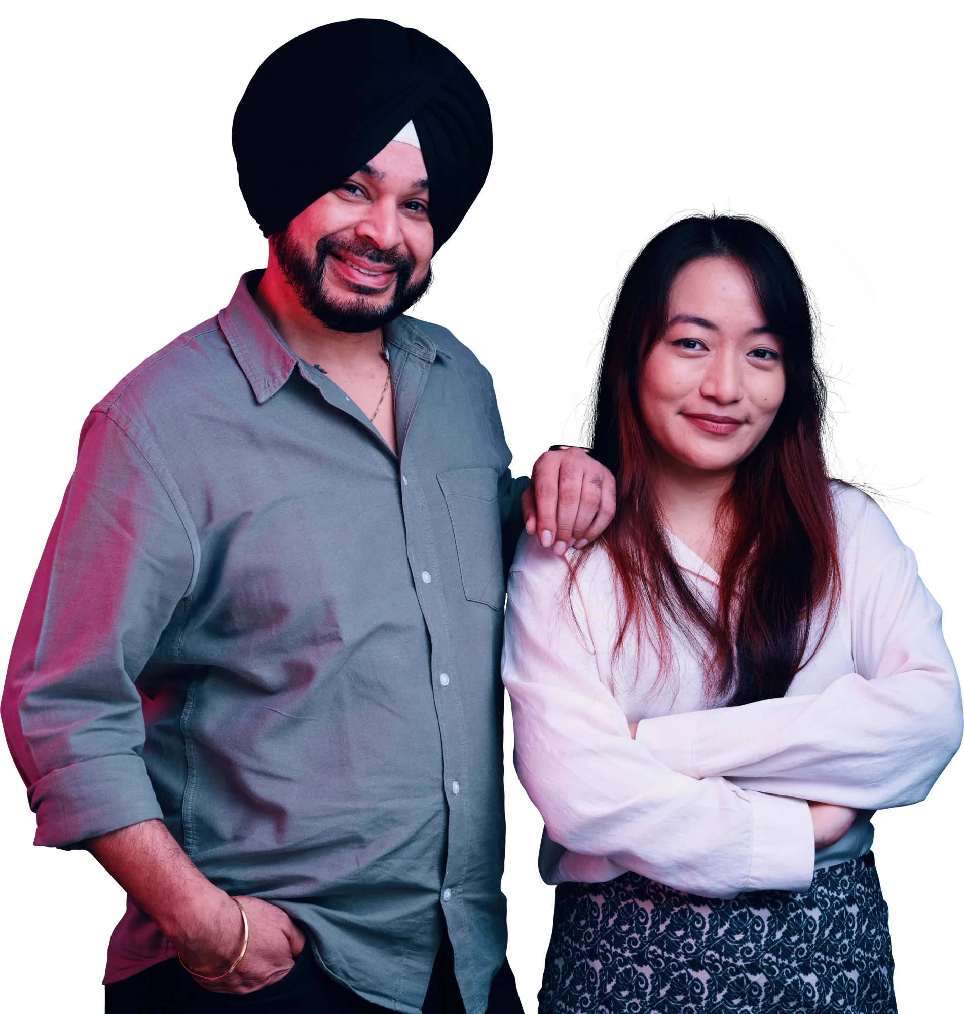 A man wearing a dark turban and a gray shirt stands beside a smiling woman in a light top.