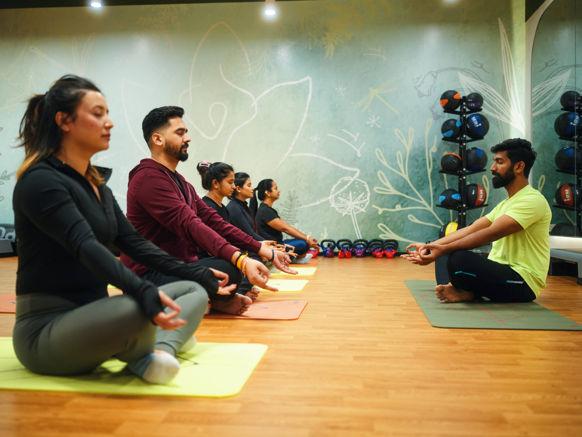 Employees meditating in a yoga class on-site.